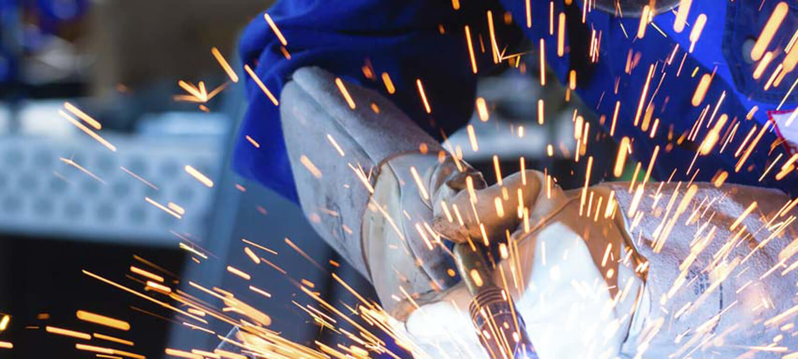 Sparks flying while welding at Taylor Made Iron Services.